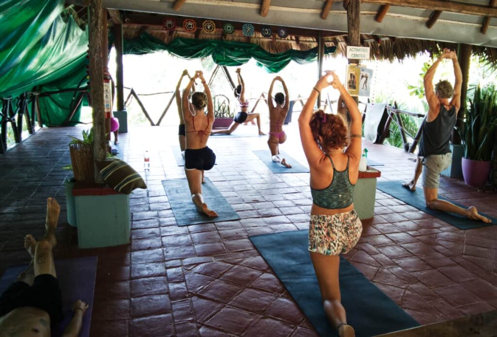 A handful of travelers pose during a yoga class at Selina, Puerto Escondido.
