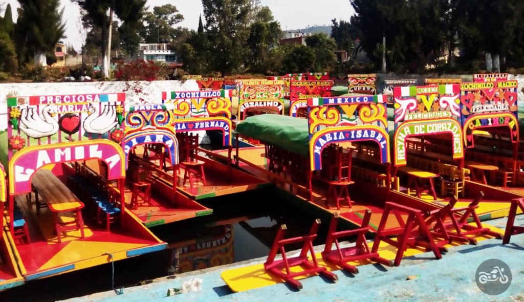 Colorful boats lined up in the canal at Xochimilco, the floating gardens near Mexico City