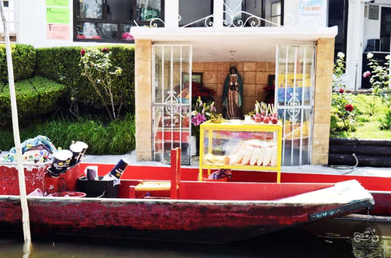 A vendors boat selling micheladas, popcorn, and candied apples