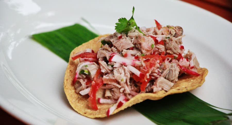 Traditional tostada with pork, radish, and tomato at Ix Cat Ik - a restaurant in Valladolid.