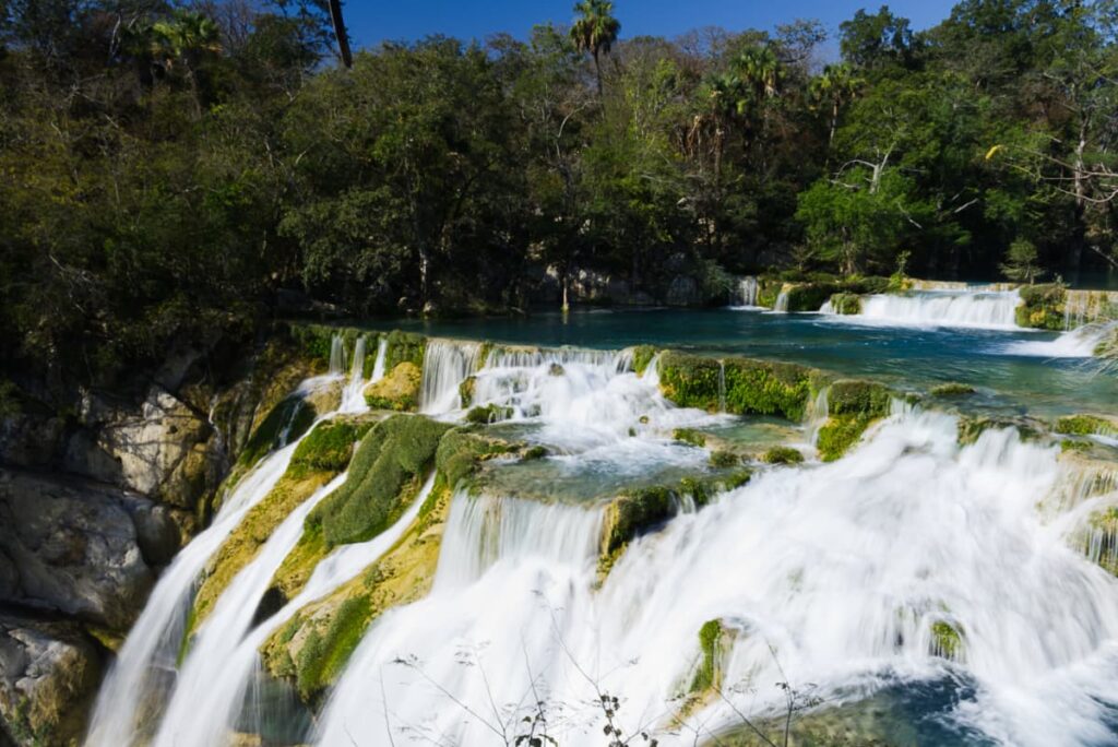 Stepped waterfalls create pools at the El Mecco Waterfall in Huasteca Potosina before plunging to the river below.