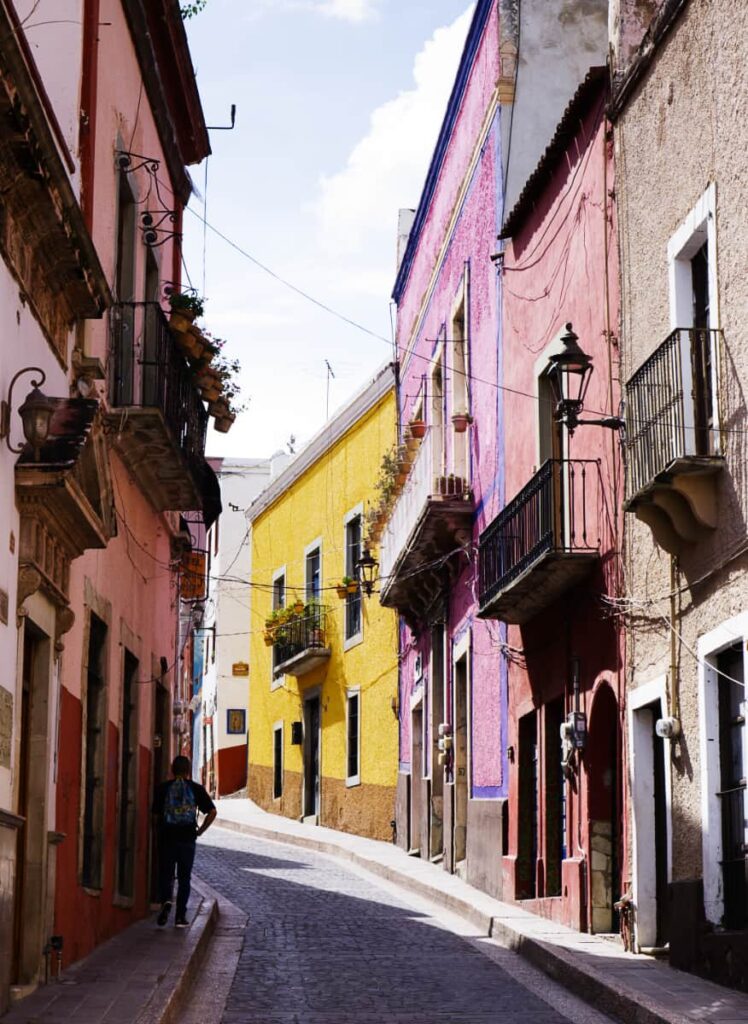 An iconic street of Guanajuato, Calle Positos has colorful buildings along its narrow paved portion.