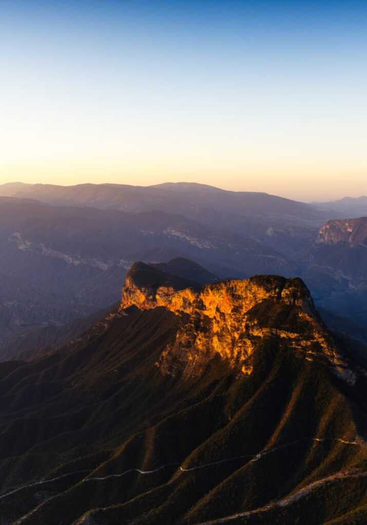 At mirador Cuatro Palos, Queretaro the sun baths the rugged rock formation that flows down into deep green mountain valleys.