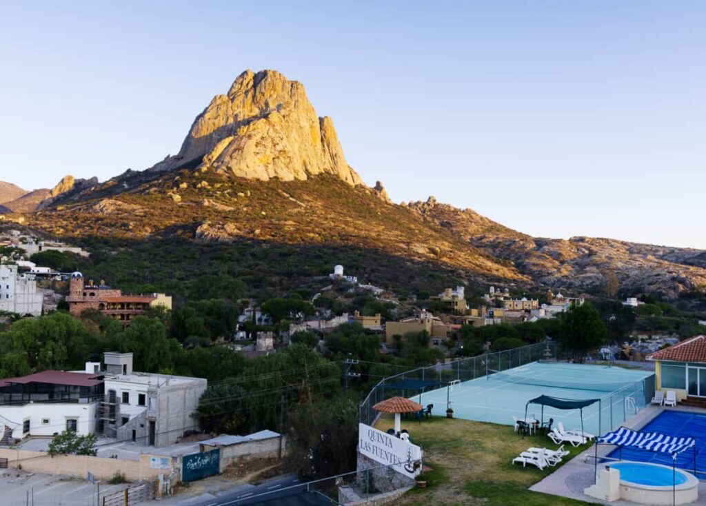 Pena de Bernal is basked in golden morning light as seen from Quinta Los Fuentes, a Bernal Queretaro hotel.