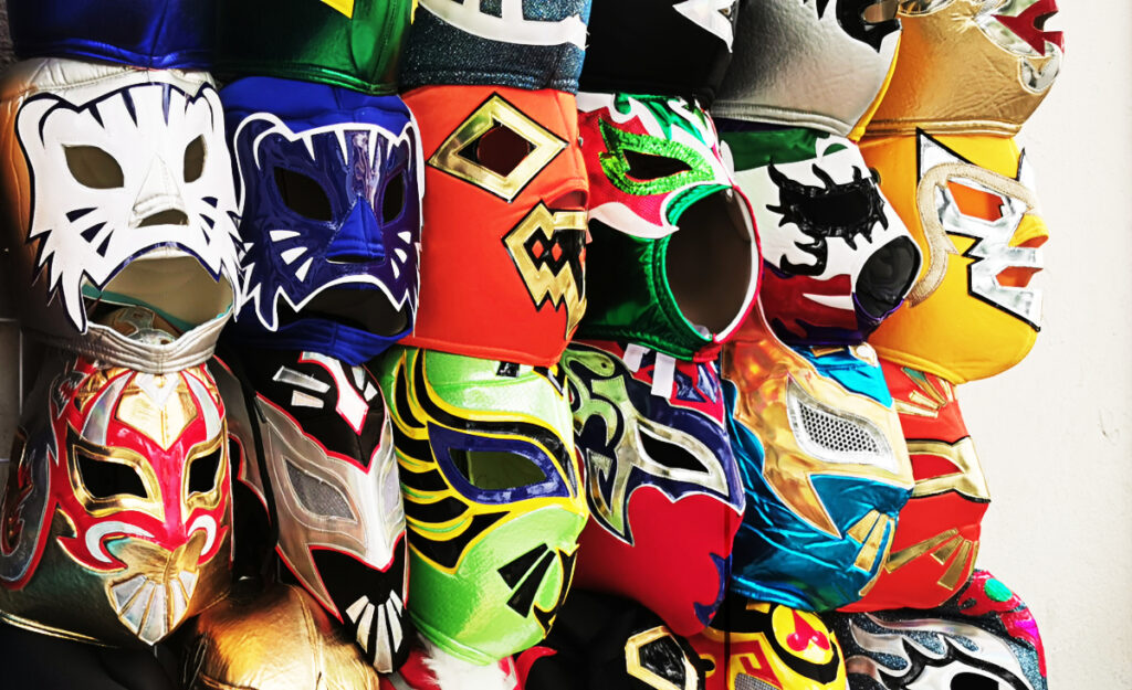 Lucha libre masks are lined up for sale outside of the arena.