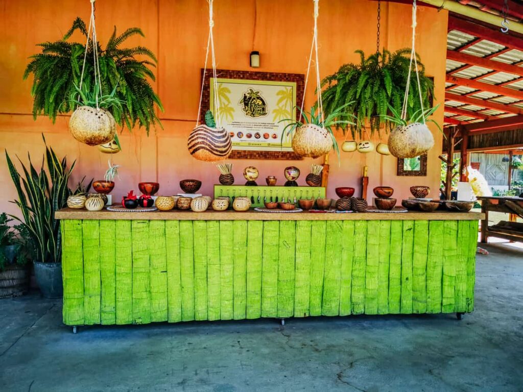 Colorful display of coconut crafts at Museo de Coco in Zihuatanejo, showcasing a variety of bowls, planters, candle holders, and other decorative items for sale.