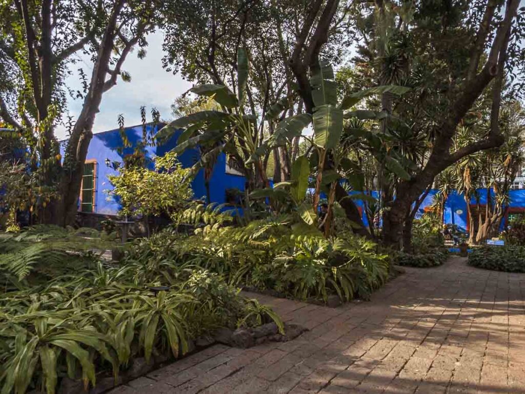 Frida Kahlo Museum, known as the 'Blue House' with lush gardens surrounding the iconic artist's former residence.
