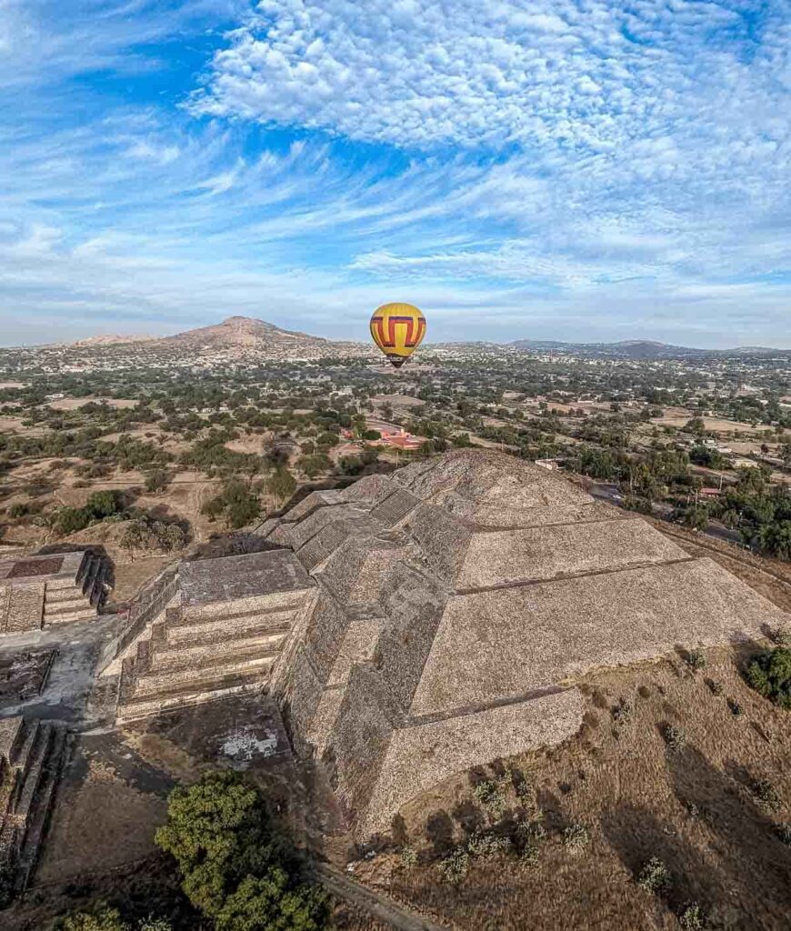 Hot air balloon flying over the Pyramid of the Moon in Teotihuacan, Mexico.