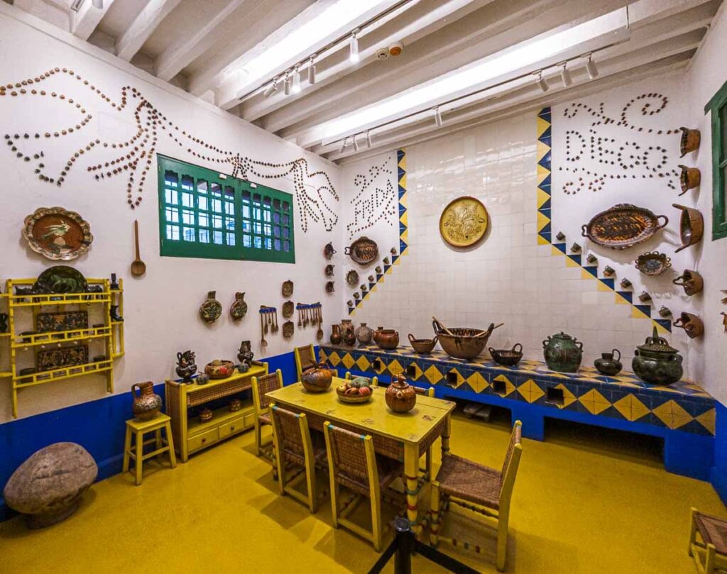 Kitchen in Casa Azul, home of Frida Kahlo and Diego Rivera, showcasing vibrant tiles and unique decor.