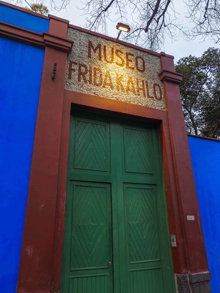 Entrance gate to Museo Frida Kahlo in Mexico with prominent 'Museo Frida Kahlo' signage