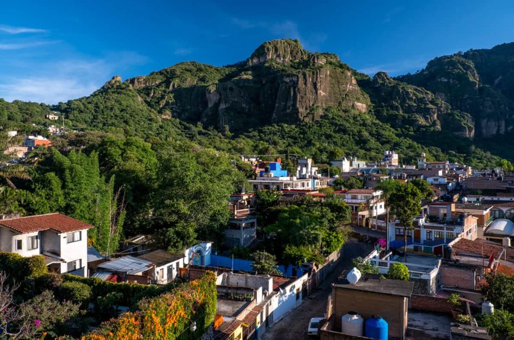 A lush, mountainous backdrop towers over the quaint town of Tepoztlán in Morelos, known for its scenic hikes and mystical energy.
