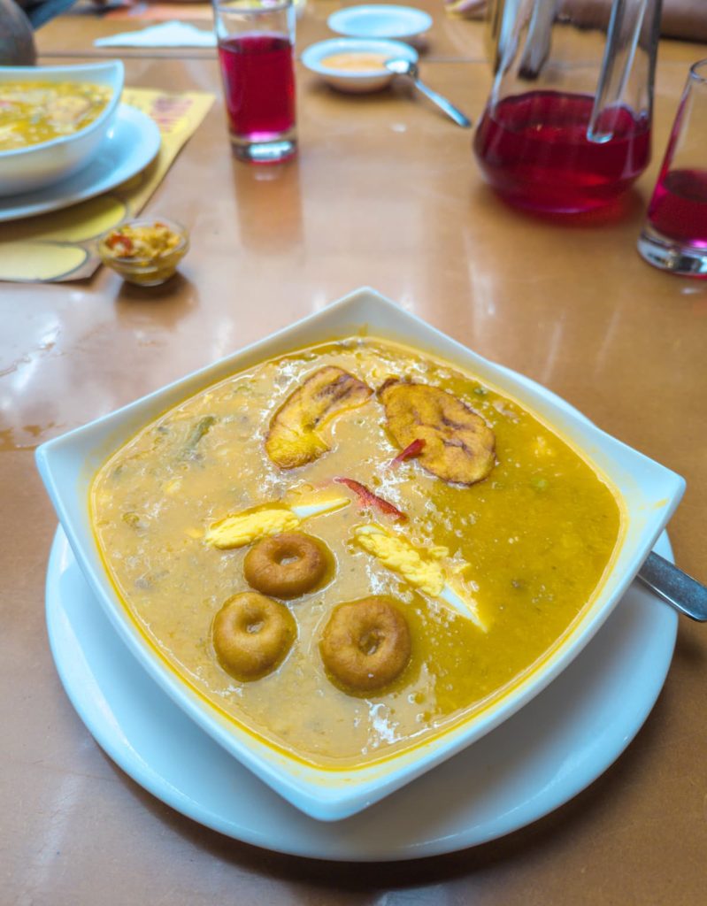 Fanesca, a thick, golden soup made with grains, pumpkin, and salt cod, garnished with fried plantains and hard boiled egg. This dish is deeply tied to Ecuadorian food culture and traditionally eaten during Holy Week.