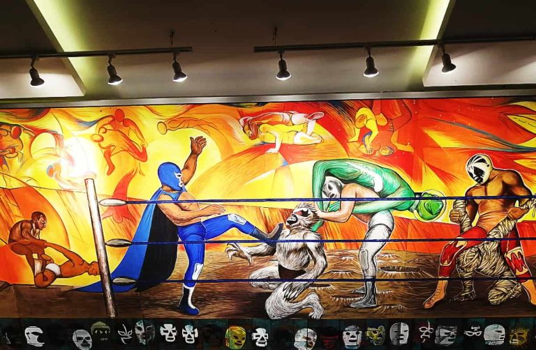 Art inside the Mexico City lucha libre arena depicts Mexican wrestlers fighting with various bad guys such as an alien and a mummy.