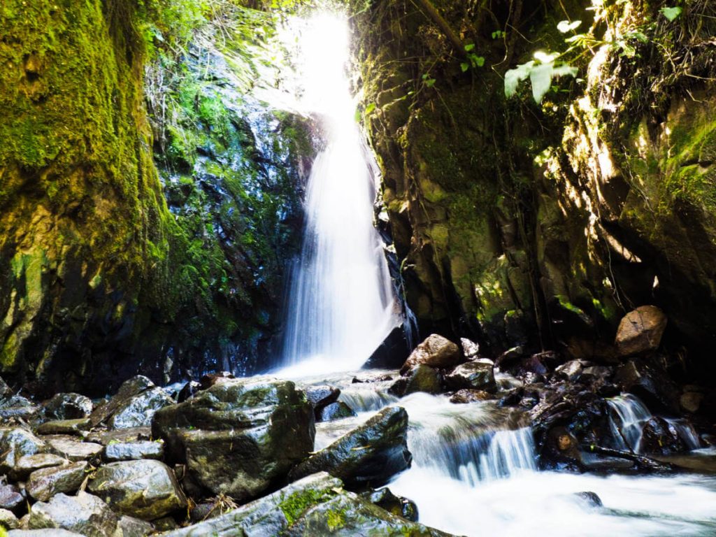 The salinas waterfall cascades down into the rocky stream below.