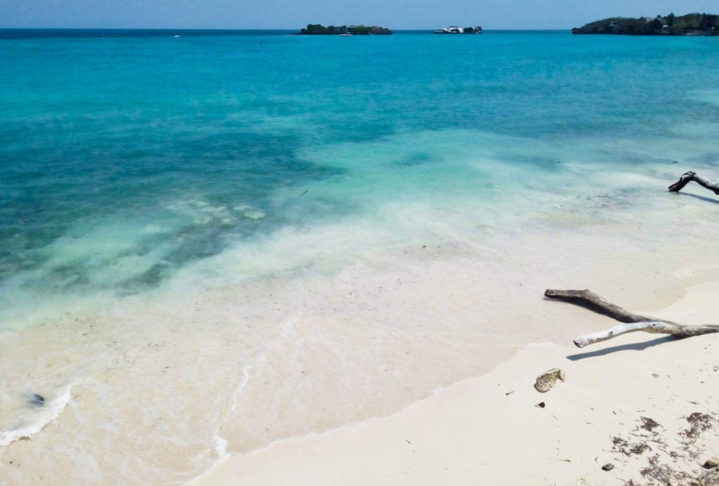 View of sand and turquoise sea from one of the best beaches in Cartagena - Playa Libre on Isla Grande.