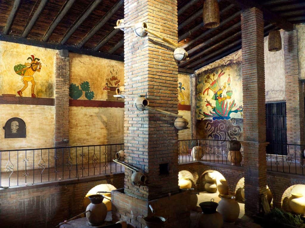 Colorful Zapotec depitions adorn the walls of the mezcal distillery at Casa Chagoya.