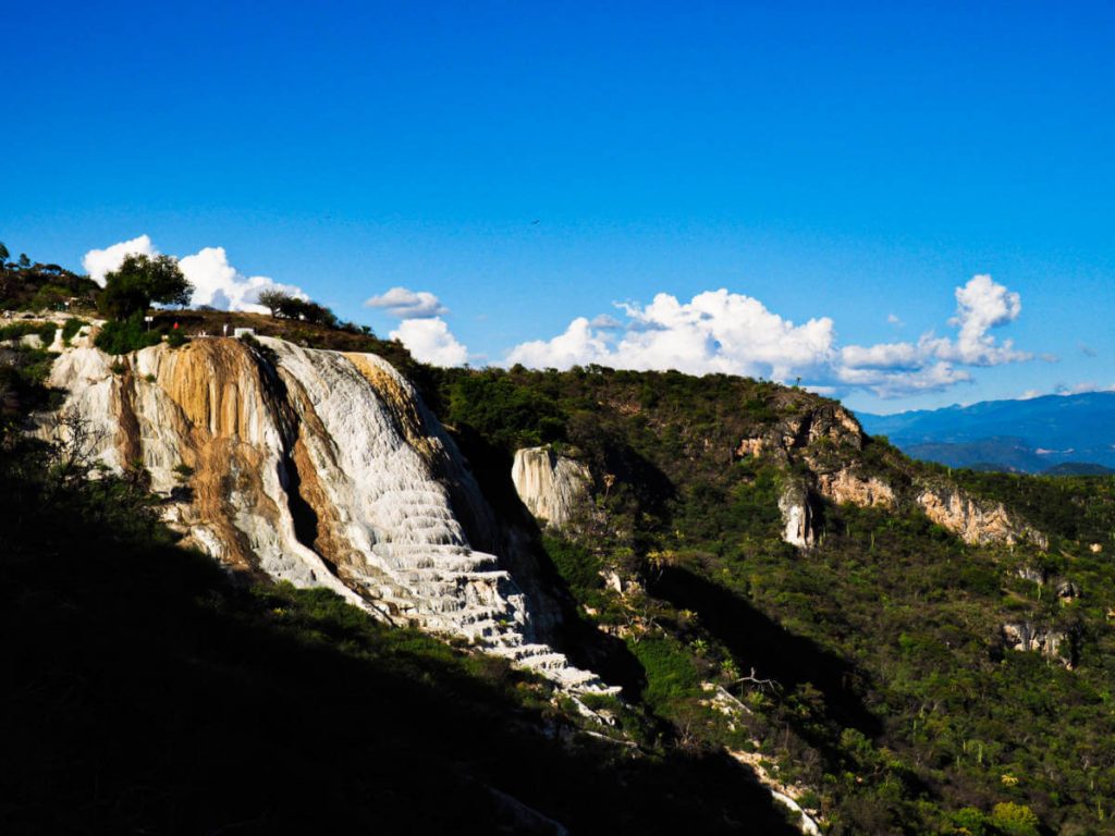 White minerals deposited on the cliff face resemble a waterfall frozen in time.