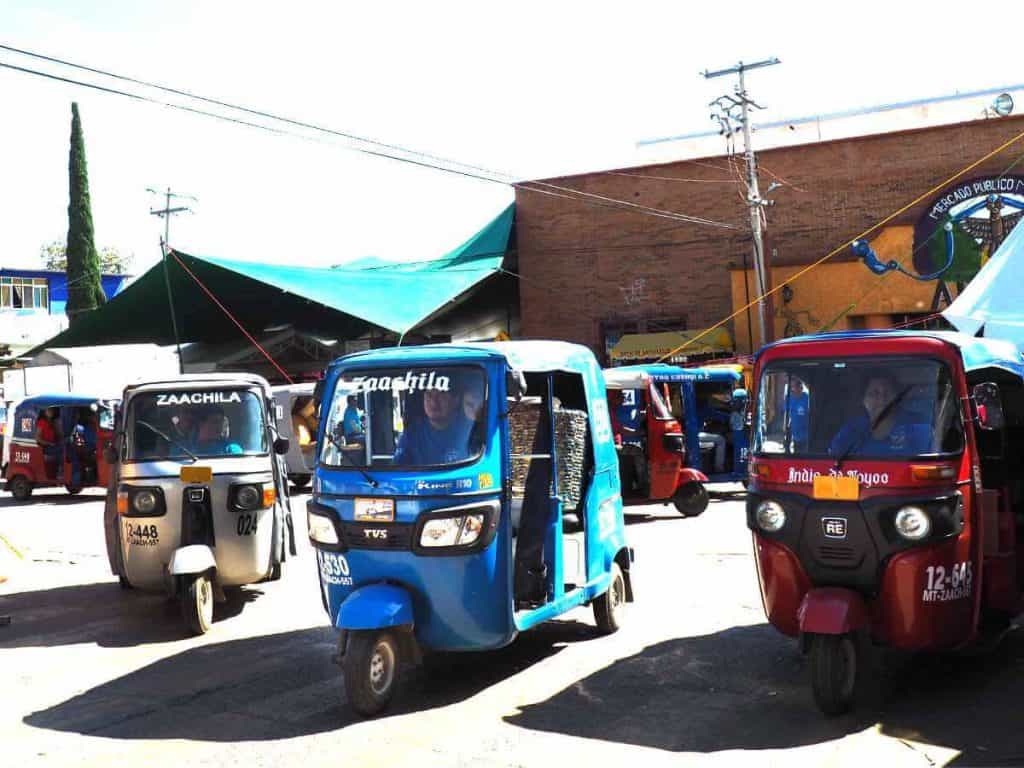 Covered three wheeled motorbikes take passengers from the Zaachila market to other small towns nearby as part of Oaxaca's public transportation.