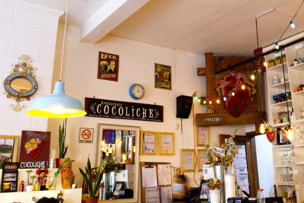 Eclectic decorations and a string of decorative lights hang behind the bar at Cocoliche Restaurant, San Cristobal de las Casas.