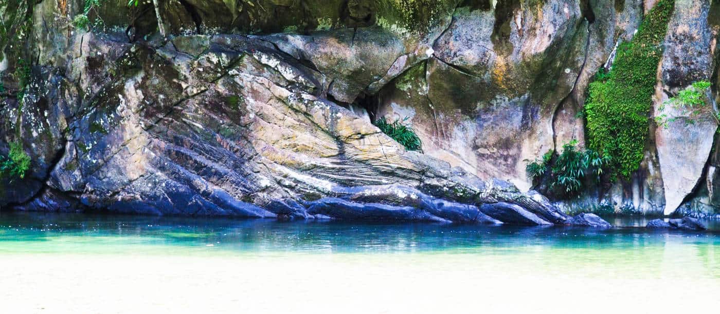 A long swatch of limestone rock forms the riverbed along the Rio Claro which has carved deep ridges in the rockface.