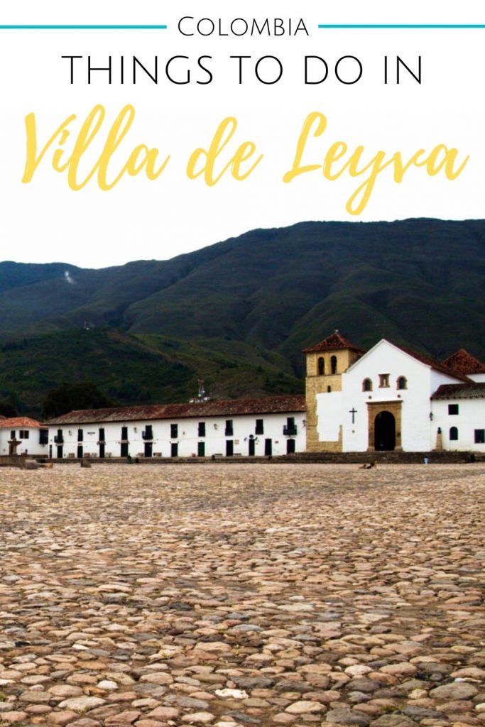 Cobblestones in the foreground of a picture of the church at Plaza Mayor in Villa de Leyva for Pinterest.
